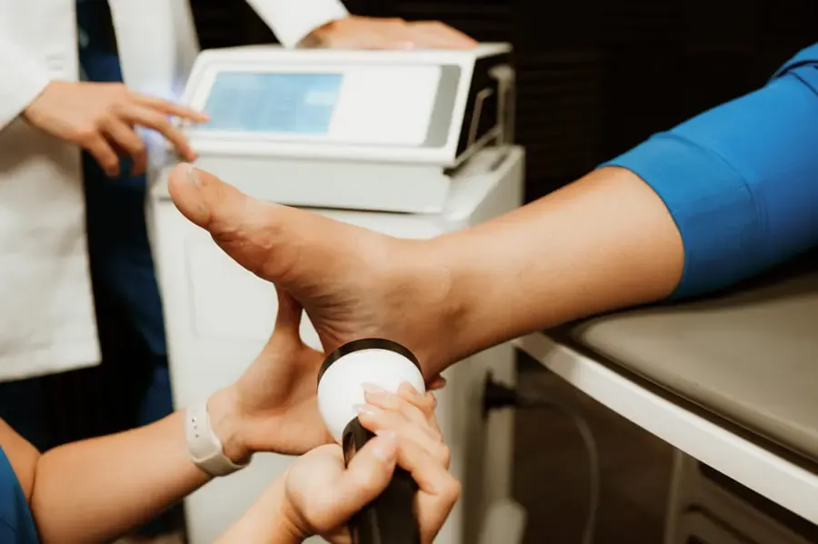 StemWave acoustic-wave therapy being applied to a patient's foot and ankle
